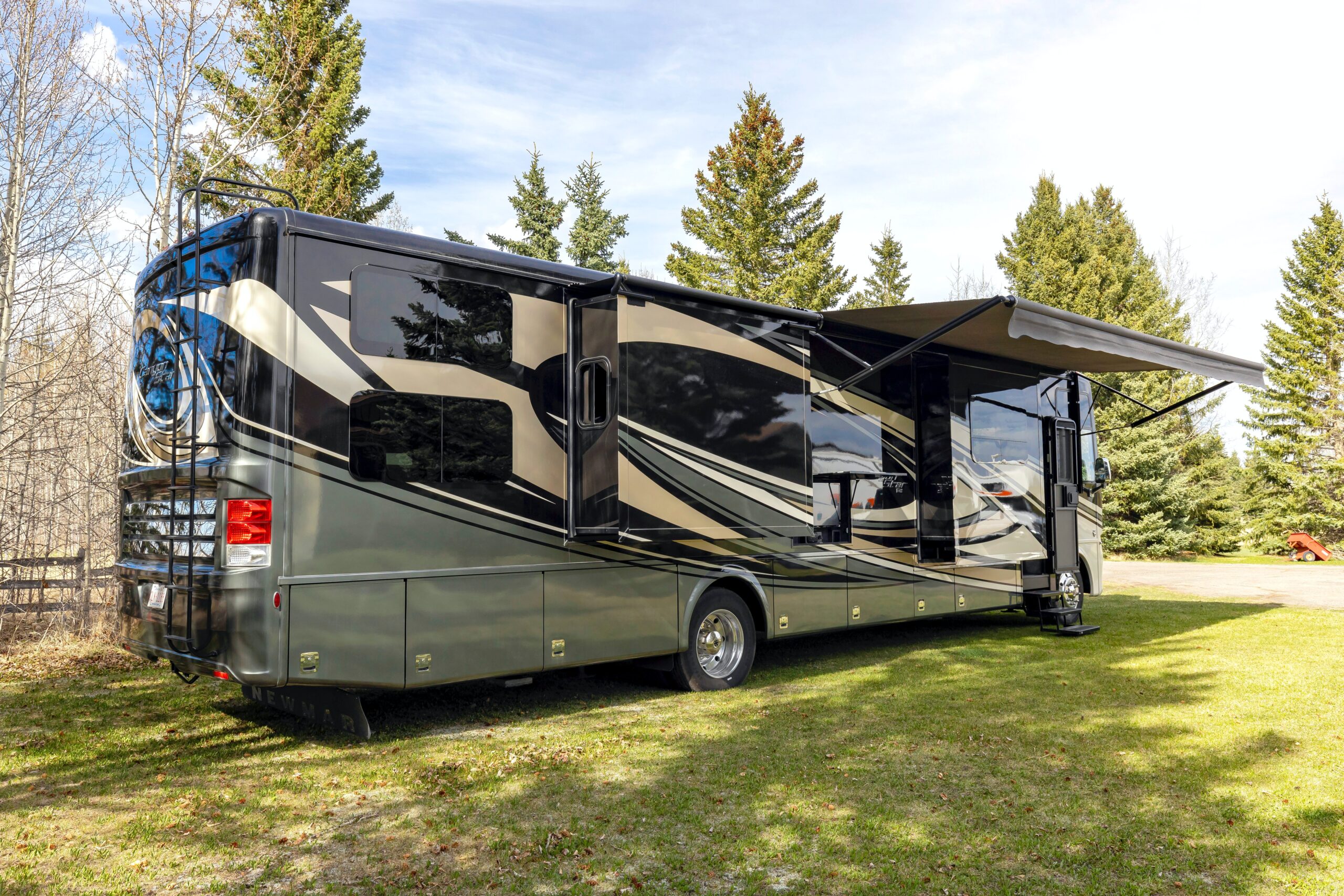 Class A suspension RV with awning out.