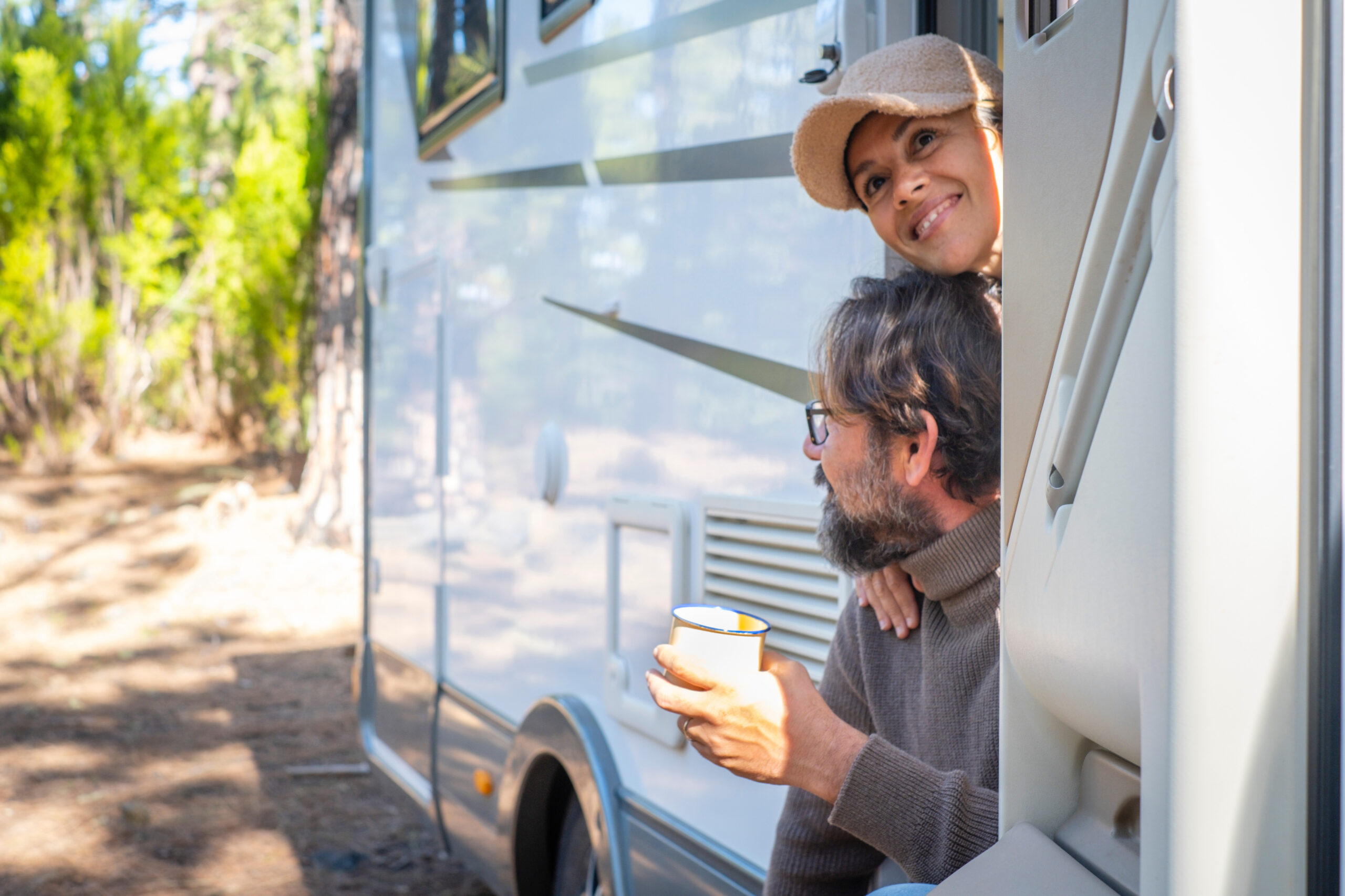 A couple enjoying their morning coffee as RVers that live in this RV
