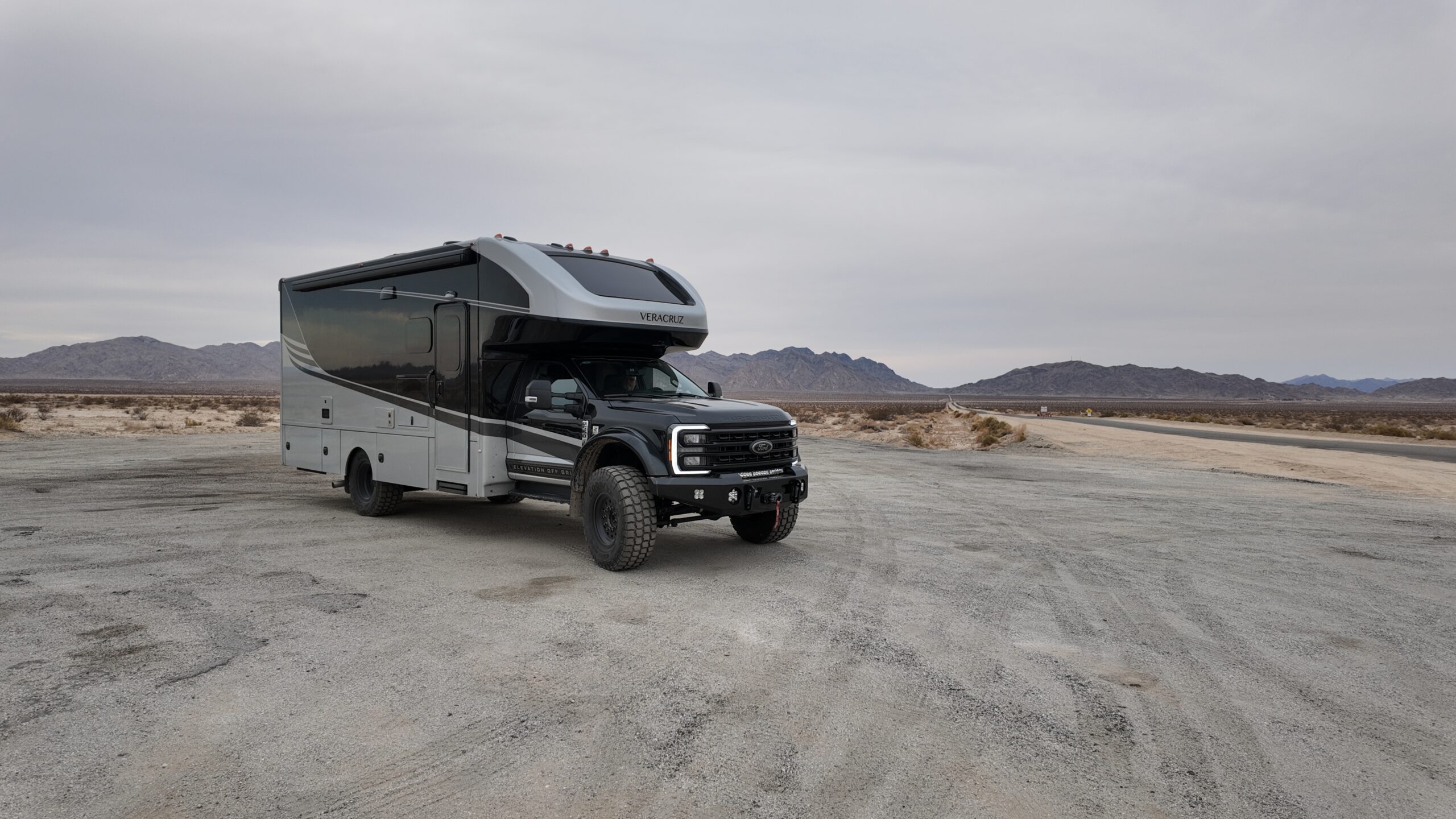 Renegade Veracruz in greya nd black parked in front of a mountain scape and grey skies