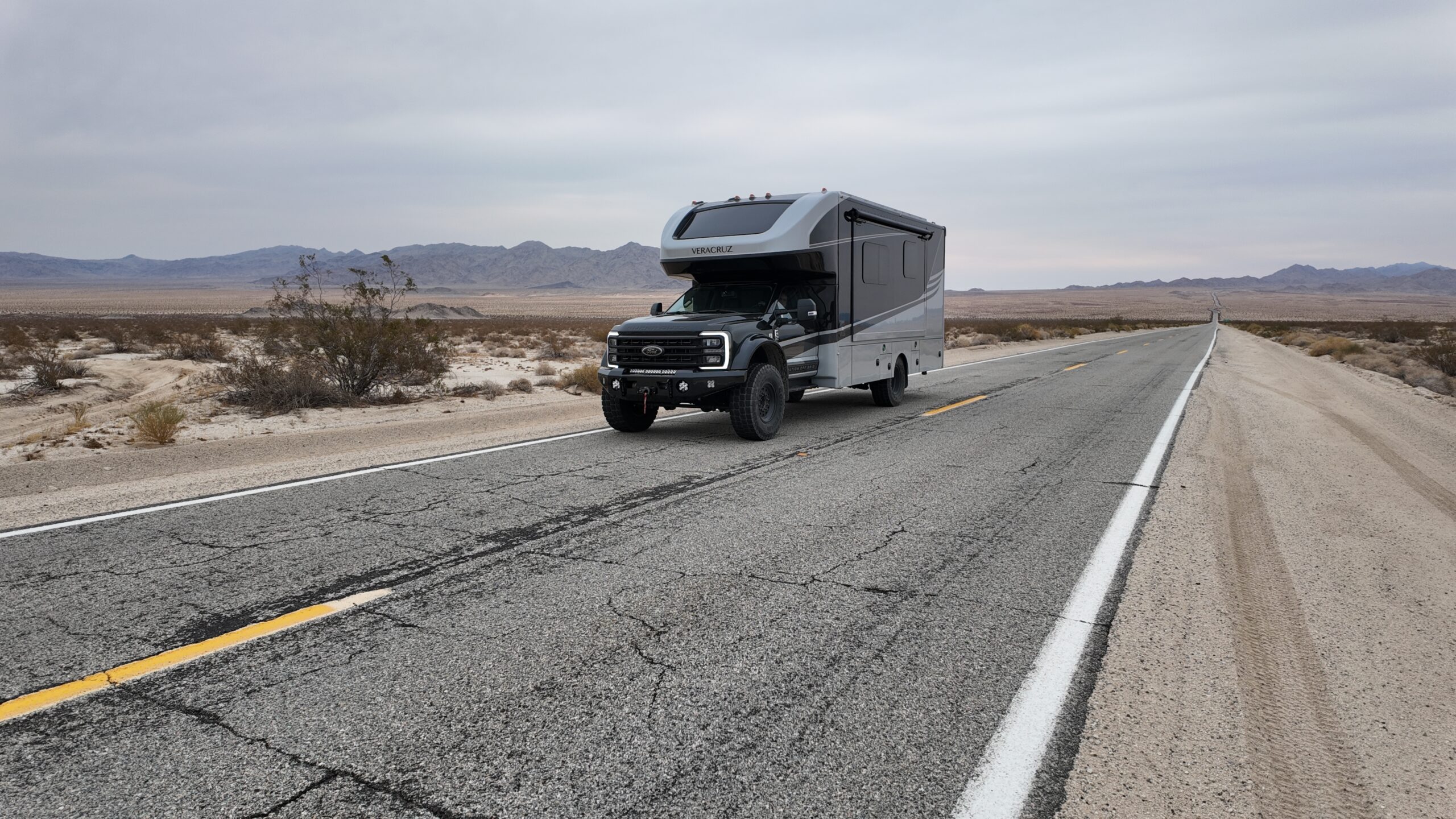 Grey camper truck driving down freeway