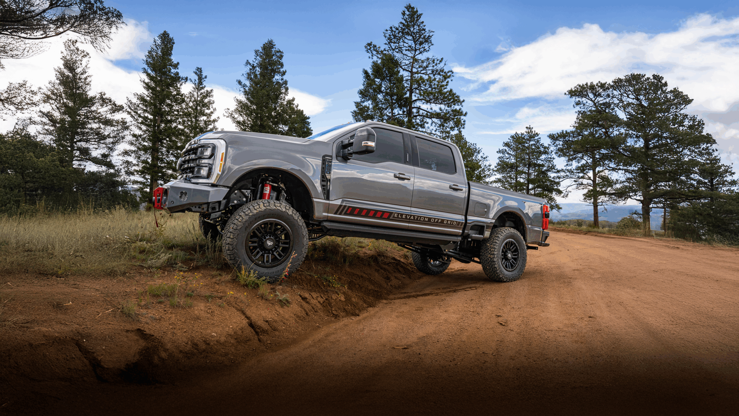 Truck with Liquid Spring suspension on an incline in front of pines