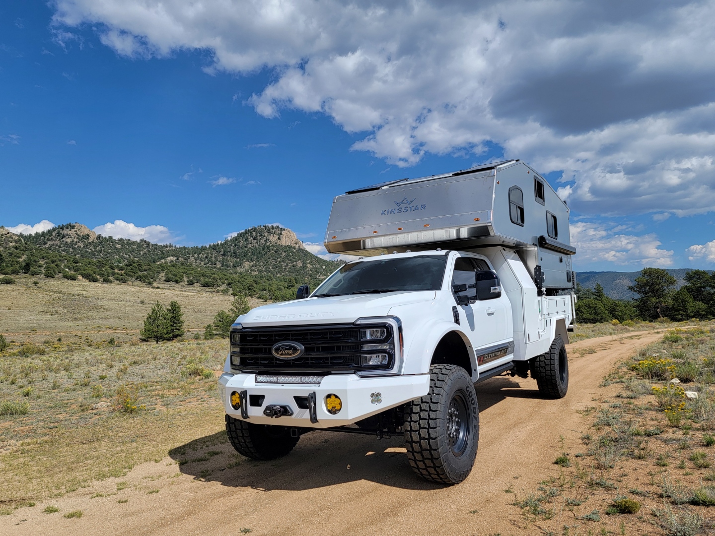White F550 truck camper build. Colorado blue sky and dirt trails 