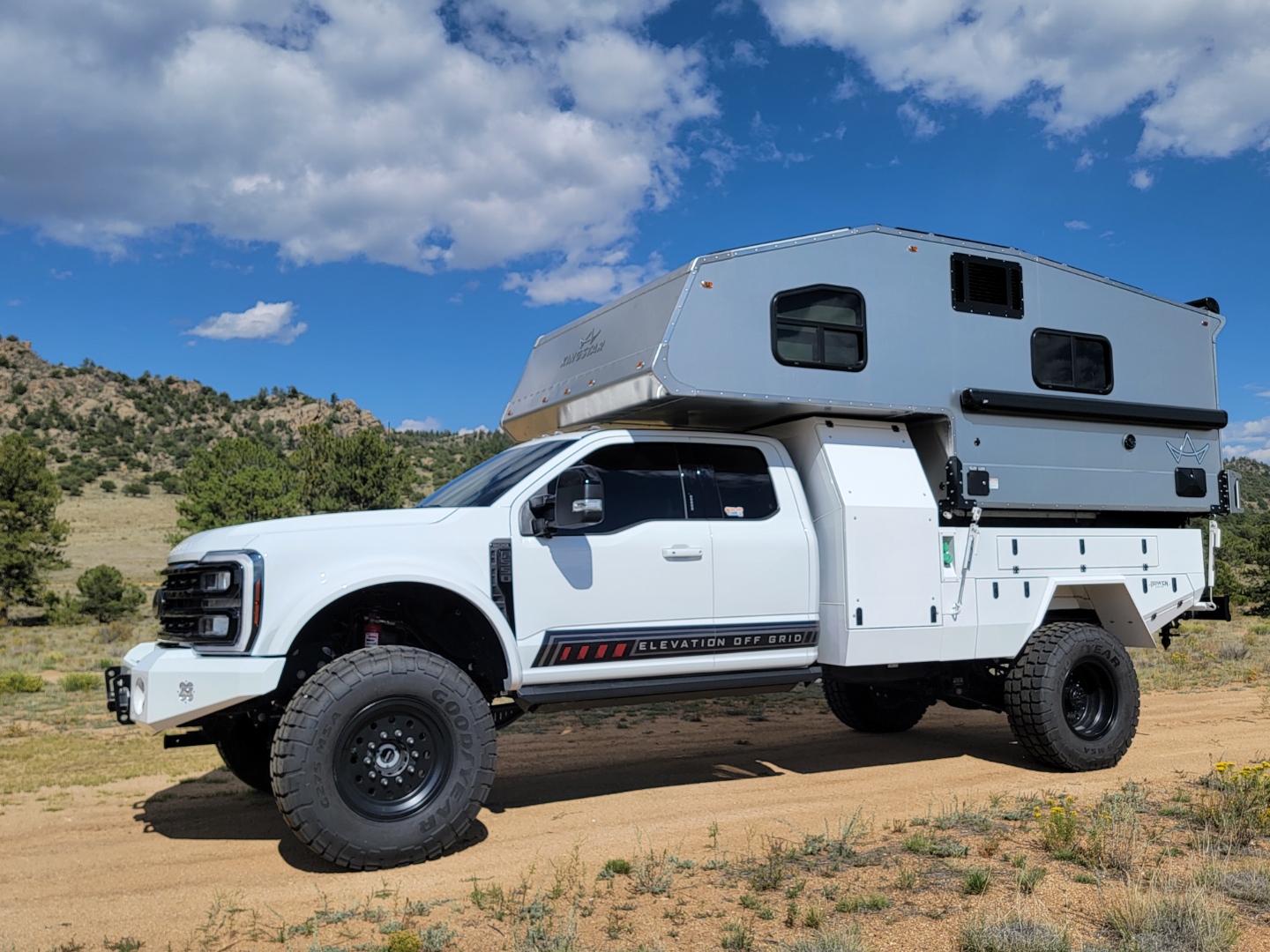 F550 truck camper build. Blue sky and dirt trails 