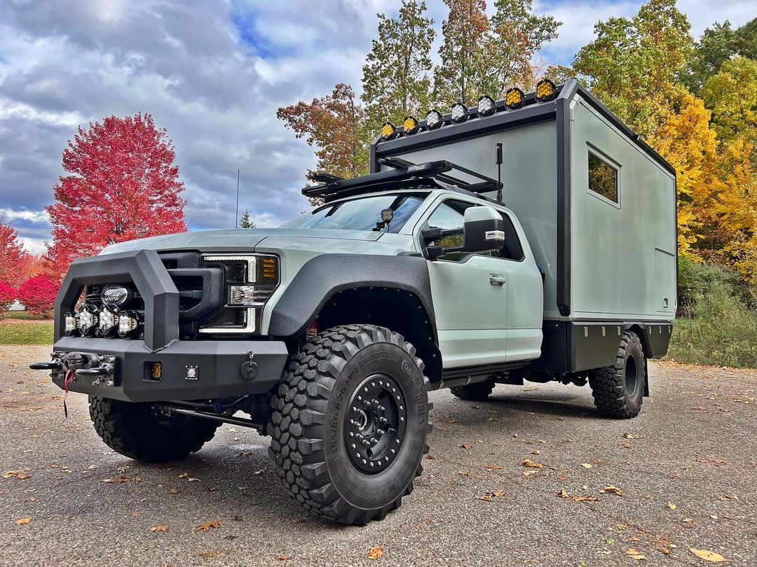 green ford with LiquidSpring suspension in fall with trees in background